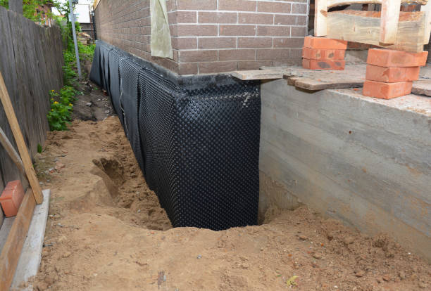 Happy homeowners after waterproofing job in Corning